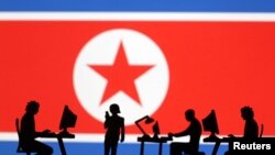 북한 인공기와 컴퓨터를 사용하는 사람들 일러스트. (자료사진)