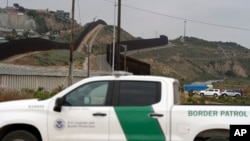 A Border Patrol vehicle sits near border walls separating Tijuana, Mexico, from the United States, June 4, 2024, in San Diego. 