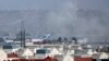 FILE - Smoke rises from a deadly explosion outside the airport in Kabul, Afghanistan, Aug. 26, 2021.