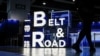 A woman walks in front of a sign at the "Belt and Road" summit in Hong Kong, China Sept. 14, 2023.