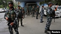 FILE - Indian security force personnel stand guard near the venue of India's Independence Day celebrations in Srinagar, Aug. 15, 2022.