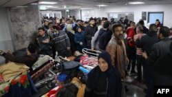 Injured people receive treatment in Gaza City's Al-Shifa hospital, following a reported Israeli strike, that according to Gaza's Health Ministry, killed at least 20 and wounded more than 150 as they waited for humanitarian aid, on Jan. 25, 2024.