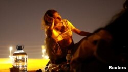 Antonela, a Venezuelan migrant who is eight months pregnant and trying to reach the United States, rests near the Rio Bravo river on the border between Mexico and the United States as seen from Ciudad Juarez, Mexico, June 4, 2024.