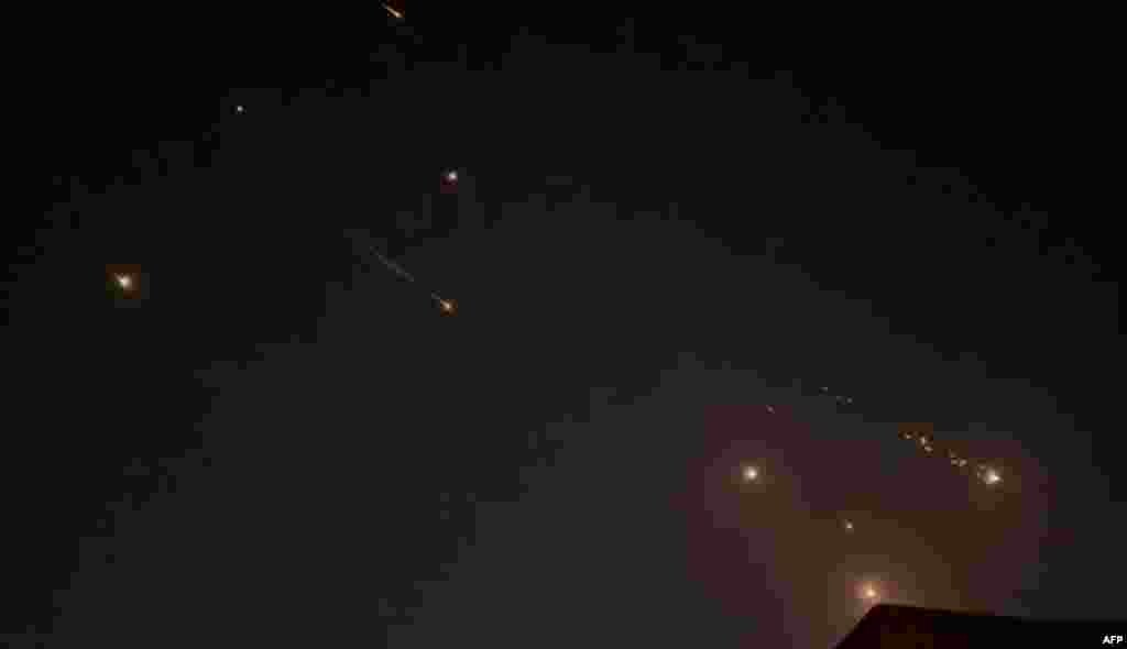 This video grab from AFPTV taken on April 14, 2024 shows explosions lighting up the sky in Hebron in the Israeli-occupied West Bank during an Iranian attack on Israel. 