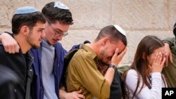 Friends of Israeli soldier Sergeant Lavi Ghasi mourn during his funeral in Modiin, Israel, Dec. 21, 2023. Ghasi, 19, was killed during the Israeli military's ground operation in the Gaza Strip.