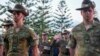 FILE - Soldiers salute during an Anzac Day dawn service at Coogee Beach in Sydney, Australia, April 25, 2024. Australia will allow non-citizens to join its armed forces, the government says. 