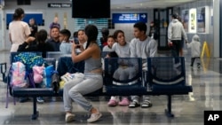 Migrants stay in a makeshift shelter at O'Hare International Airport, Sept. 20, 2023, in Chicago.