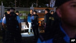 Police officers stop and search people near Victoria Park, Hong Kong's traditional venue for the annual 1989 Tiananmen Square crackdown vigil, in Hong Kong, June 4, 2024.