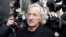 FILE - Journalist, John Pilger, a supporter of Wikileaks founder Julian Assange arrives at the City of Westminster Magistrates Court in London where Julian Assange is in court for his bail hearing, Tuesday, Dec. 14, 2010.