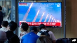 A TV screen shows a report of North Korea's multiple rocket launchers during a news program at the Seoul Railway Station in Seoul, South Korea, May 31, 2024. 
