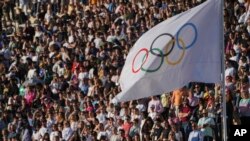 The Olympic flag flies during the Olympic flame handover ceremony, April 26, 2024, in Athens, at Panathenaic stadium, where the first modern games were held in 1896.