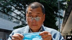 FILE - Hong Kong media tycoon Jimmy Lai, who founded the since-shuttered local newspaper Apple Daily, enters a court in Hong Kong on May 5, 2020.