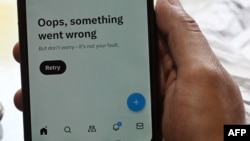 FILE - In this photo illustration, a man tries to access the social media platform X, formerly known as Twitter, on his phone at a market in Islamabad, Pakistan, April 17, 2024.