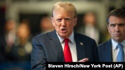 Former President Donald Trump speaks to the media outside of his trial at Manhattan Criminal Court, May 28, 2024, in New York. 