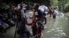FILE - Haitian migrants wade through water as they cross the Darien Gap from Colombia to Panama in hopes of reaching the U.S., May 9, 2023. 