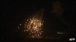 An Israeli strike illuminates the sky above the southern Lebanese village of Khiam, April 17, 2024.