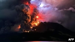 This handout photograph taken and released by the Center for Volcanology and Geological Hazard Mitigation on April 17, 2024, shows Mount Ruang spewing hot lava and smoke as seen from Sitaro, North Sulawesi.