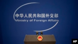 FILE - A podium with the national emblem of the People's Republic of China and a logo for China's Ministry of Foreign Affairs are seen before a daily briefing at the ministry's office in Beijing, China, Nov. 19, 2015.