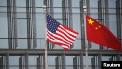Bendera China dan AS berkibar di luar gedung perusahaan AS di Beijing, Ibu Kota China (Foto: ilustrasi). 