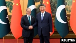 Chinese President Xi Jinping, right, and Pakistani Prime Minister Shehbaz Sharif shake hands at the Great Hall of the People in Beijing, China, June 7, 2024.