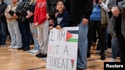 FILE - Mourners attend a vigil for Wadea Al-Fayoume, 6, a Muslim boy who police say was stabbed to death in an attack that targeted him and his mother for their religion and the Israel-Gaza war, in Plainfield, Illinois, Oct. 17, 2023.