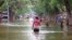 In this image made from video, residents move through floodwaters on a street in the town of Beledweyne, Somalia, Nov. 19, 2023. Officials say a cholera outbreak that started in Somalia in January is a consequence of the flooding in October and November.
