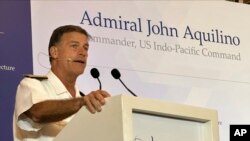 FILE - Admiral John Aquilino delivers a speech in Singapore, in this photo released by IISS on March 16, 2023.