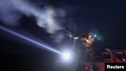 A Ukrainian serviceman from an anti-drone mobile air defense unit fires a machine gun during combat, amid Russia's attack on Ukraine, in Chernihiv region, Ukraine, March 28, 2024.