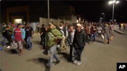 FILE - In this image from a video, a migrants caravan leaves San Pedro Sula, Honduras, Jan. 20, 2024, in hopes of reaching the United States. 