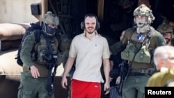 Rescued Hamas hostage Andrei Kozlov is escorted by Israeli forces in Ramat Gan, Israel, June 8, 2024.