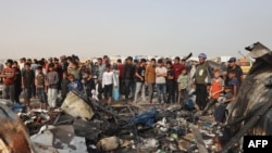 巴勒斯坦民众聚集在加沙南部拉法城一个遭以色列空袭的难民营前。（2024年5月27日）