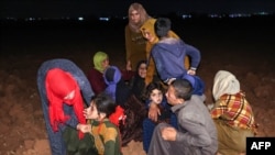 People react in the aftermath of Syrian government forces' bombardment at a camp for those displaced by conflict in Sarmin in the rebel-held part of Syria's northwestern Idlib province, Sept. 23, 2023. 