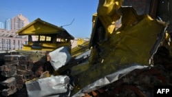 A photograph shows a hole in a roof of a multistore building damaged as a result of falling debris after a massive drone attack overnight in Kyiv on May 20, 2023.