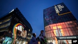 People shop at Taikoo Li Sanlitun in Beijing, China, July 2, 2024. Surveys of Chinese factory managers showed a mixed outlook for the world's second-largest economy in June, with growth steady but not picking up much steam.