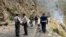 File - Security personnel inspect the site of a suicide attack near Besham city, Shangla district of Khyber Pakhtunkhwa province, March 26, 2024. Five Chinese nationals working on a dam construction site were killed when a suicide bomber targeted their vehicle.