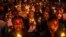 Young Rwandans hold flameless candles while taking part on a vigil during the commemorations of the 30th Anniversary of the 1994 Rwandan genocide at the BK Arena in Kigali, April 7, 2024. 