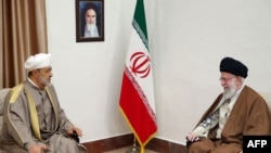 This handout picture provided by the office of Iran's Supreme Leader Ayatollah Ali Khamenei shows him, right, during a meeting with Oman's Sultan Haitham bin Tariq al-Said in Tehran, on May 29, 2023. (AFP Photo/Ho/Khamenei.ir)