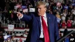 FILE - Republican presidential candidate and former President Donald Trump arrives for a campaign rally in Erie, Pennsylvania, July 29, 2023.