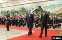 FILE - Chinese President Xi Jinping and Maldivian President Mohamed Muizzu attend a welcome ceremony at the Great Hall of the People in Beijing, China, Jan. 10, 2024. The Maldives government has been taking steps to move closer to India’s rival, China. (CNSPhoto via Reuters)