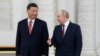 FILE - Russian President Vladimir Putin, right, speaks to Chinese President Xi Jinping as they attend an official welcome ceremony at The Grand Kremlin Palace, in Moscow, March 21, 2023.