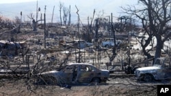 Destroyed homes and cars are shown, Aug. 13, 2023, in Lahaina, Hawaii.
