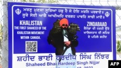 FILE - A poster of the former Gurdwara President Hardeep Singh Nijjar is displayed on a fence outside the Guru Nanak Sikh Gurdwara temple in Surrey, British Columbia, Canada, on Sept. 19, 2023.