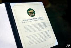 A document is displayed after a news conference between South Korea's President Yoon Suk Yeol, President Joe Biden and Japan's Prime Minister Fumio Kishida on Aug. 18, 2023, at Camp David, near Thurmont, Md.