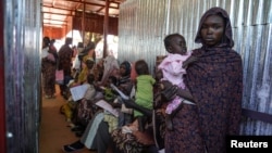 FILE - A handout photograph, taken in January 2024, shows a woman and baby at the ZamZam displacement camp in North Darfur, Sudan. (MSF/Mohamed Zakaria/Handout via Reuters)