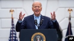 US President Joe Biden speaks during a barbecue with active-duty military service members and their families on the South Lawn of the White House, July 4, 2024, in Washington. 
