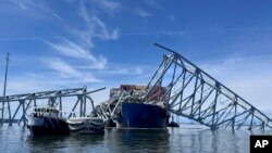 The fallen Francis Scott Key Bridge in Baltimore is pictured March 31, 2024, where divers assisted crews with the complicated and meticulous operation of removing steel and concrete. 