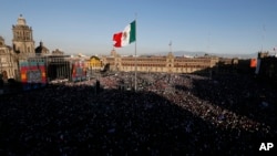 FILE - People gather in the Zocalo to celebrate Mexico's newly sworn-in president, Andres Manuel Lopez Obrador, in Mexico City, Dec. 1, 2018.