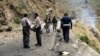 FILE - Security personnel inspect the site of a suicide attack in the Shangla district of Pakistan's Khyber Pakhtunkhwa province on March 26, 2024. Five Chinese nationals working on a construction site were killed along with their driver by a suicide bomber.