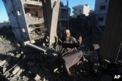 A Palestinian reacts after an Israeli strike on residential buildings in Rafah, Gaza, on Dec. 15, 2023.