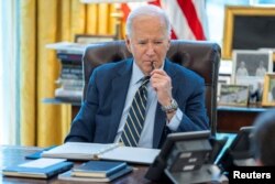 U.S. President Joe Biden speaks on the phone with Israeli Prime Minister Benjamin Netanyahu in this White House photo taken in the Oval Office in Washington, April 4, 2024.